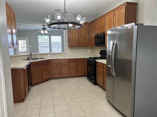 kitchen with a sink, black appliances, brown cabinets, decorative backsplash, and visible vents