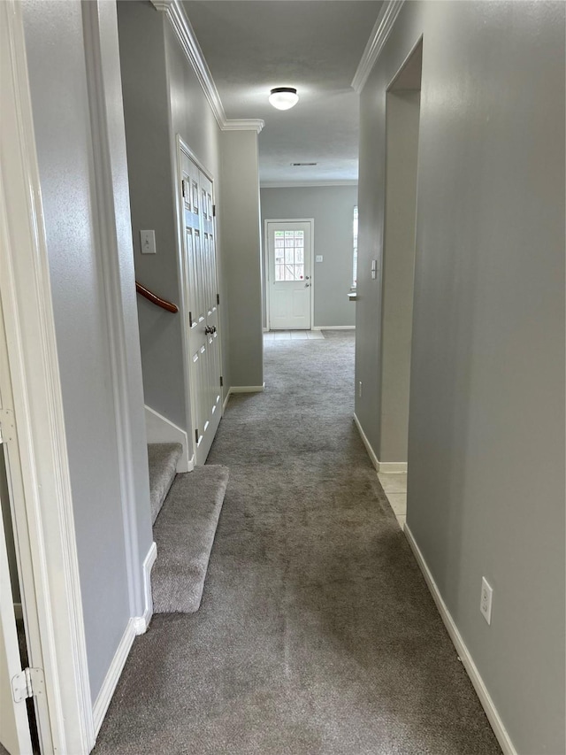hallway featuring carpet, stairs, baseboards, and ornamental molding