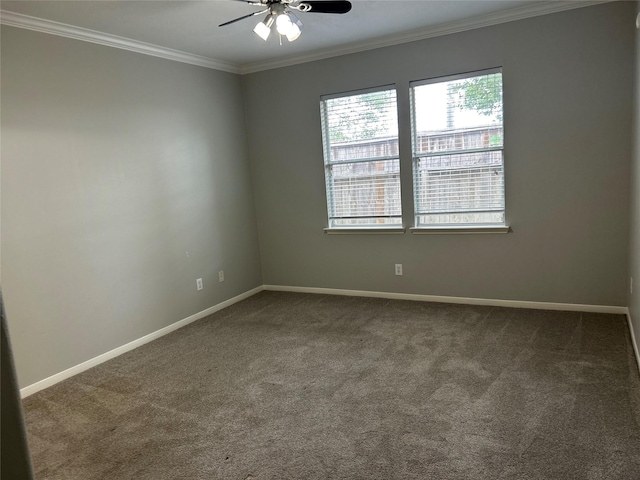 carpeted empty room featuring ceiling fan, baseboards, and crown molding