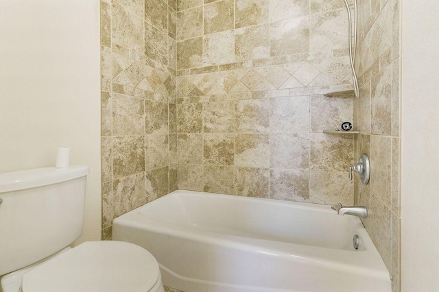 bathroom featuring toilet and tiled shower / bath combo