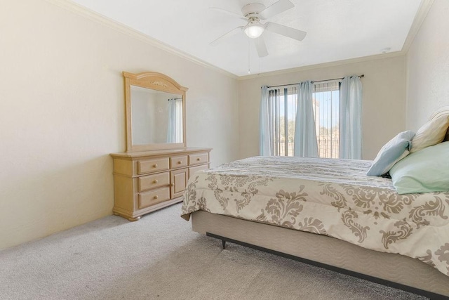 carpeted bedroom featuring crown molding and ceiling fan