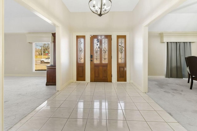 carpeted foyer featuring an inviting chandelier