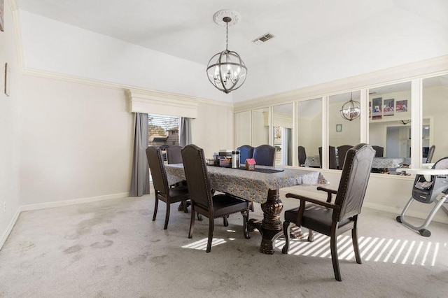 dining room featuring a notable chandelier and light colored carpet