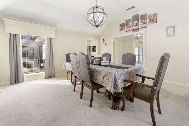 dining area featuring an inviting chandelier, light colored carpet, crown molding, and vaulted ceiling