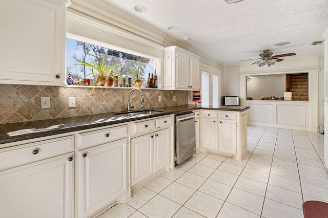 kitchen featuring decorative backsplash, dishwasher, white cabinets, and kitchen peninsula