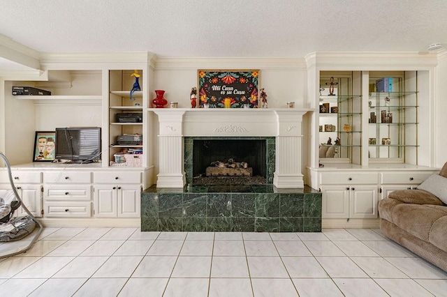 living room featuring a fireplace, a textured ceiling, and light tile patterned flooring