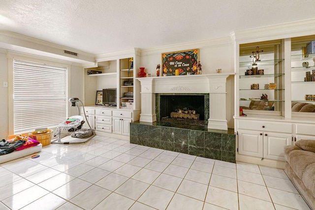 living room featuring light tile patterned floors, a fireplace, ornamental molding, and a textured ceiling