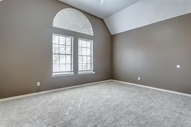 empty room with carpet and lofted ceiling