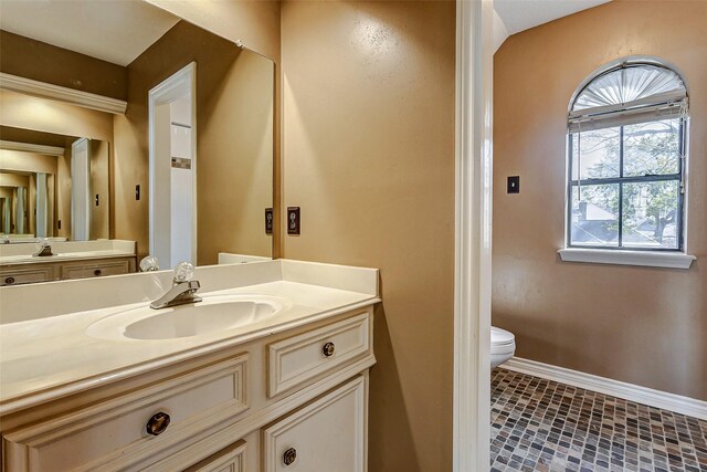 bathroom with vanity and toilet