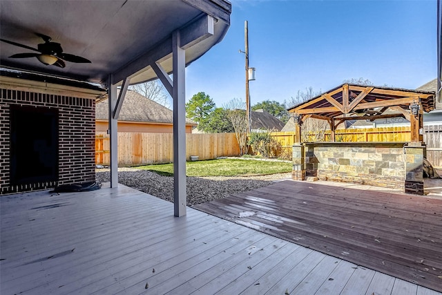 wooden deck featuring ceiling fan