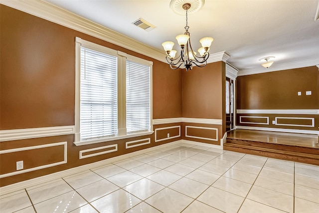 unfurnished room with ornamental molding, light tile patterned floors, and an inviting chandelier