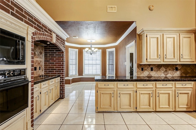 kitchen with pendant lighting, crown molding, black appliances, light tile patterned flooring, and dark stone counters