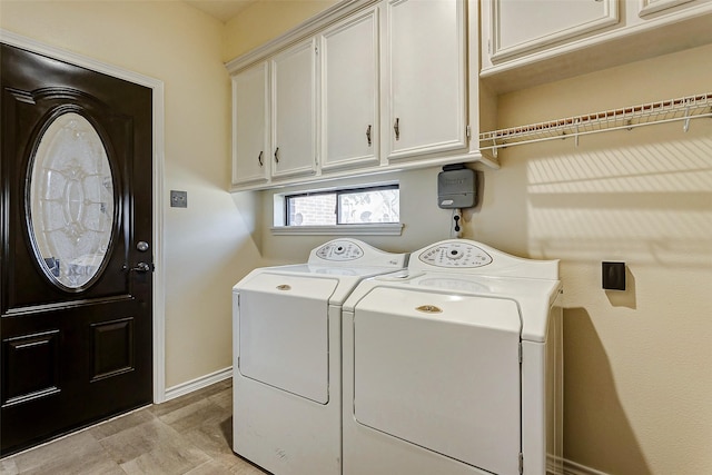 washroom with cabinets and washer and clothes dryer