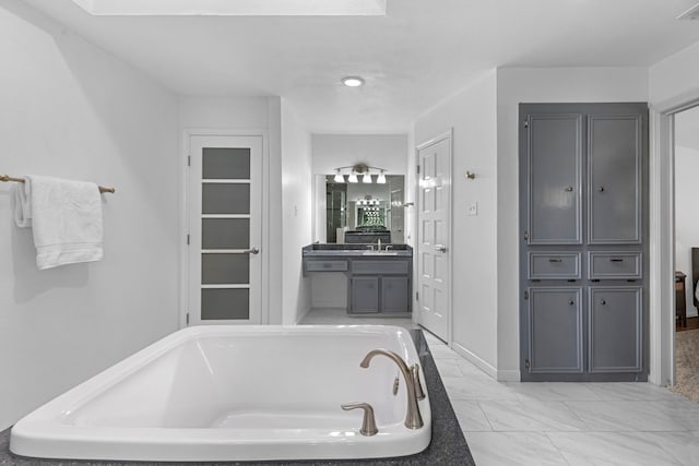 full bath featuring visible vents, a closet, a garden tub, and vanity