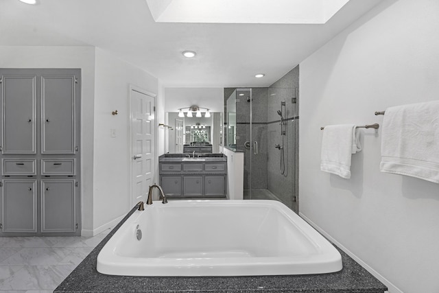 bathroom with a bathtub, marble finish floor, a stall shower, vanity, and baseboards