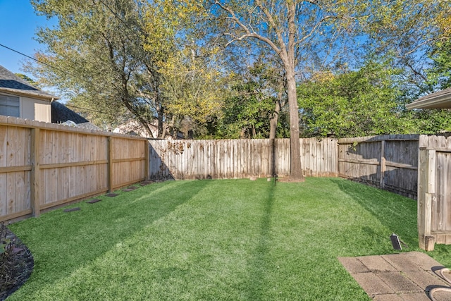 view of yard with a fenced backyard