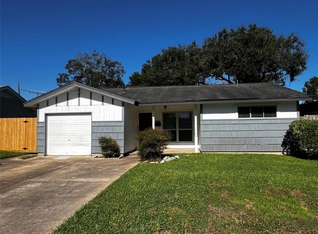 ranch-style house featuring a garage and a front lawn