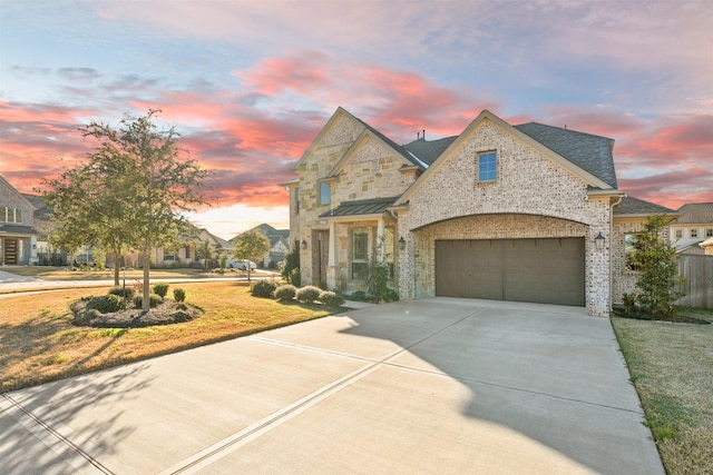 view of front facade with a garage and a lawn