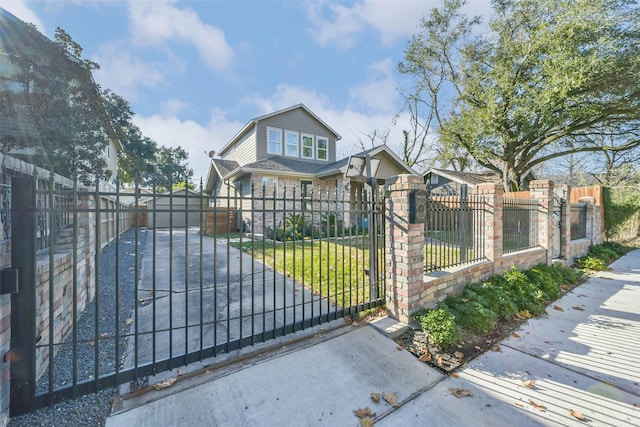 view of gate with a yard and an outdoor structure