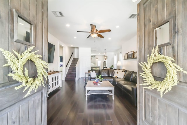 living area featuring wood finished floors, visible vents, recessed lighting, ceiling fan, and stairs
