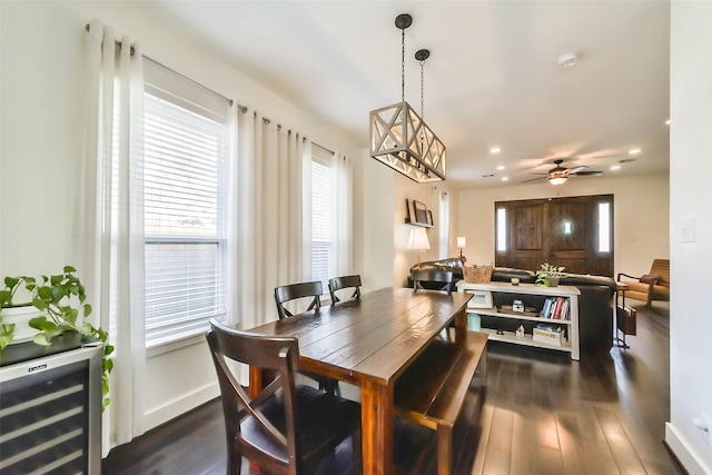 dining space featuring beverage cooler, recessed lighting, baseboards, ceiling fan, and dark wood-style flooring