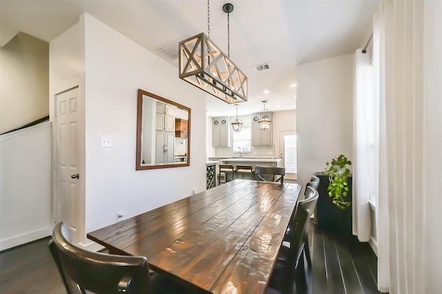 dining space with visible vents, baseboards, dark wood finished floors, a chandelier, and recessed lighting