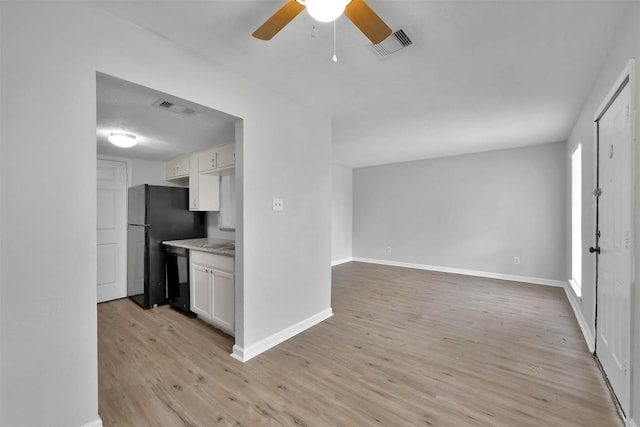 kitchen with white cabinetry, light hardwood / wood-style flooring, ceiling fan, and black appliances