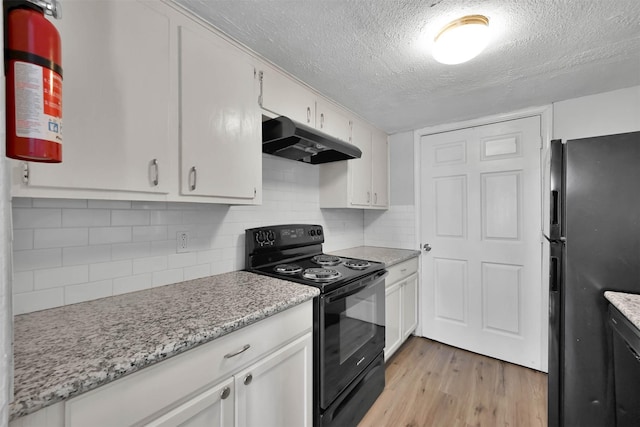 kitchen featuring white cabinetry, black appliances, light hardwood / wood-style floors, a textured ceiling, and decorative backsplash