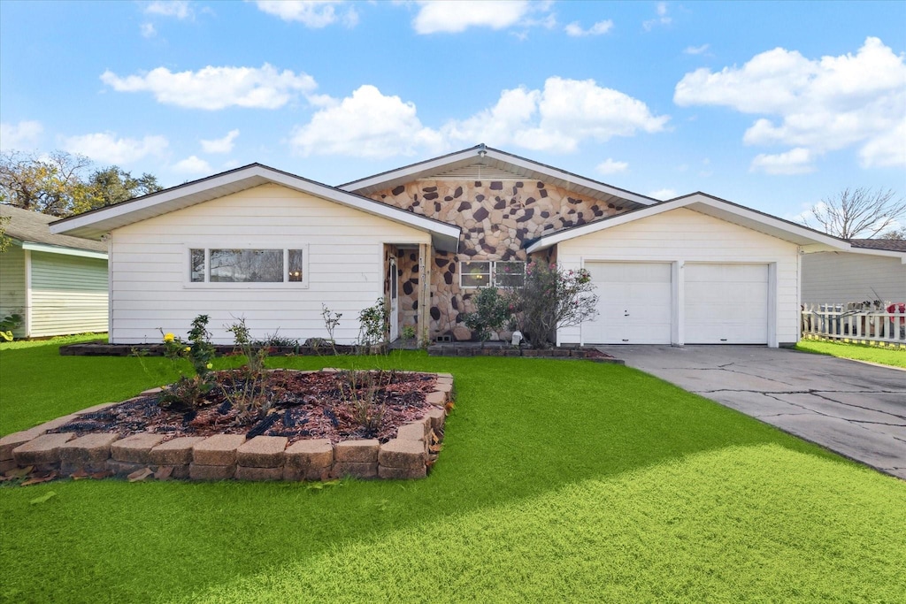 single story home with a garage and a front yard