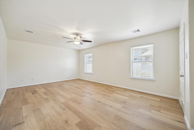 spare room featuring light hardwood / wood-style floors and ceiling fan