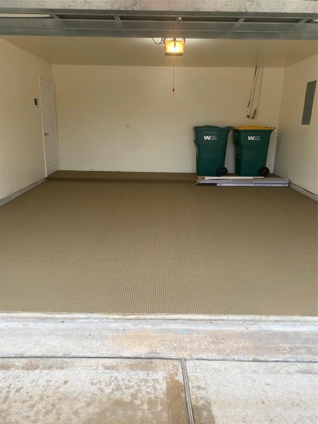 garage with a garage door opener and electric panel