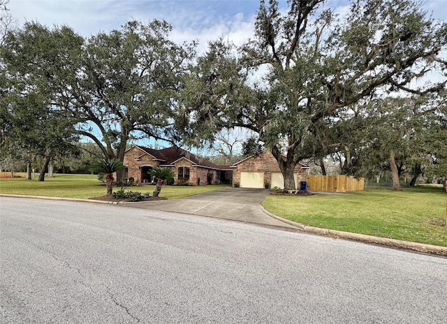 ranch-style home featuring a garage and a front lawn