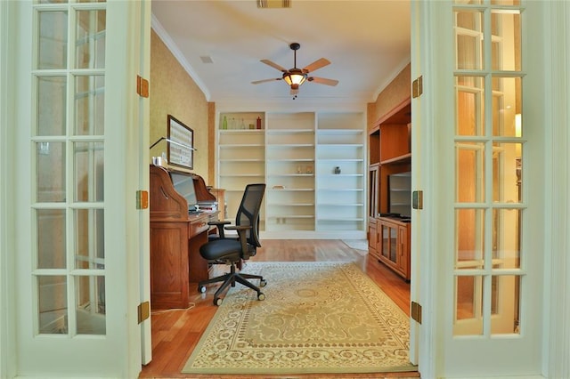 office with crown molding, light hardwood / wood-style floors, french doors, and ceiling fan