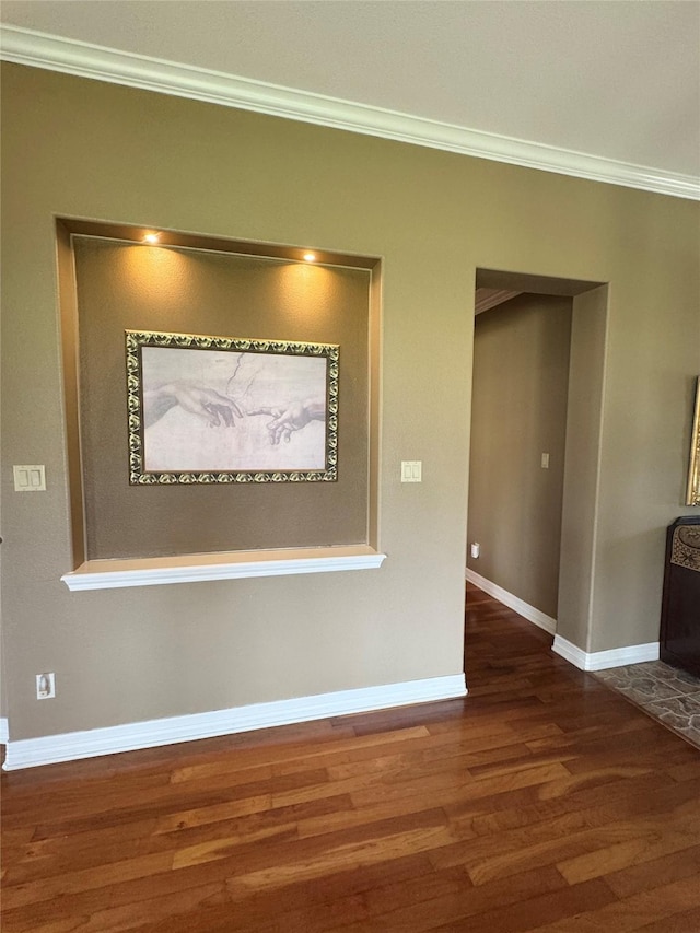 hall with ornamental molding and dark wood-type flooring