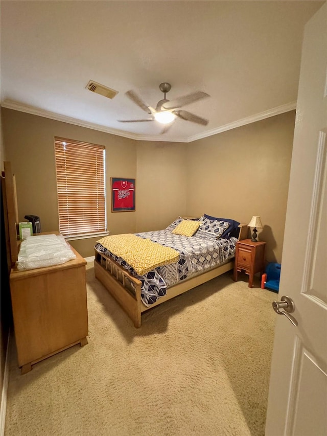 carpeted bedroom featuring crown molding and ceiling fan