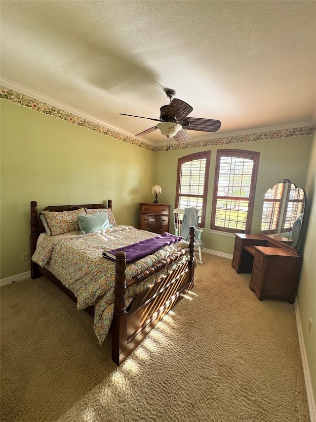 carpeted bedroom featuring ornamental molding, a textured ceiling, and ceiling fan