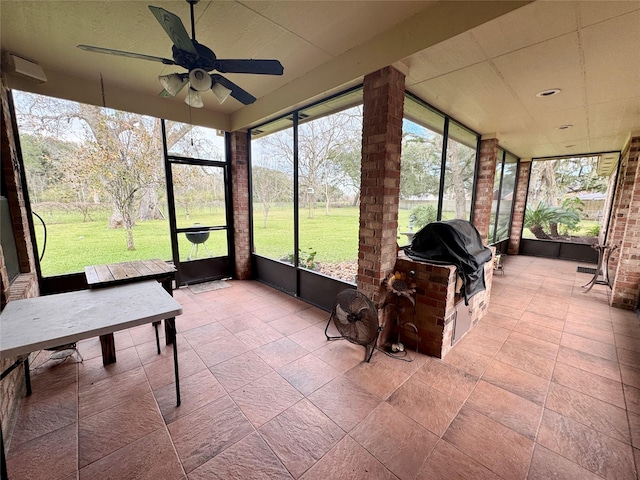 sunroom / solarium featuring ceiling fan