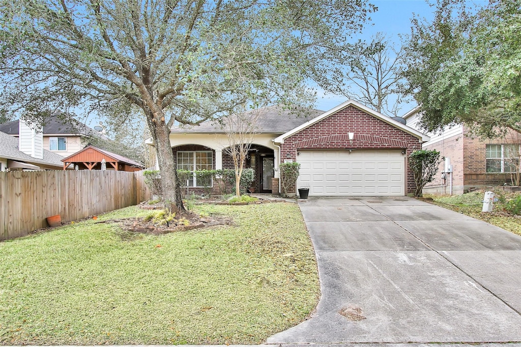 view of front of house featuring a garage and a front lawn