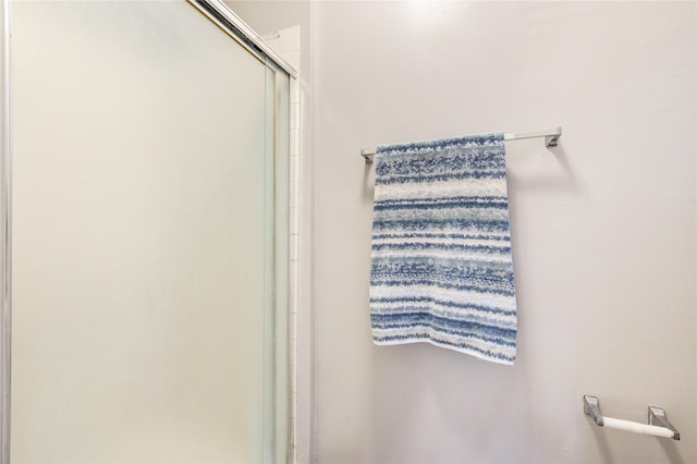 bathroom with a shower with shower door