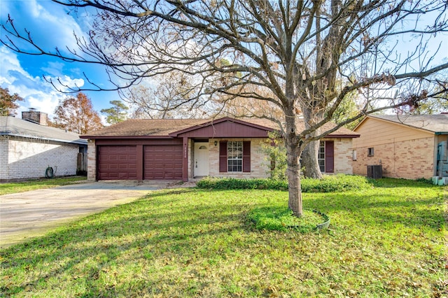 ranch-style home featuring central AC, a garage, and a front lawn