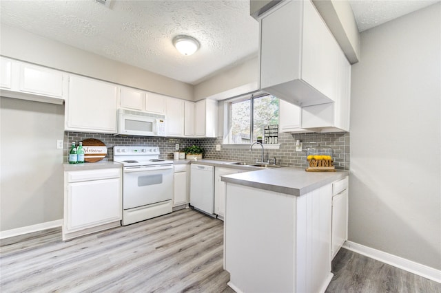 kitchen with white cabinetry, sink, light wood-type flooring, white appliances, and a textured ceiling