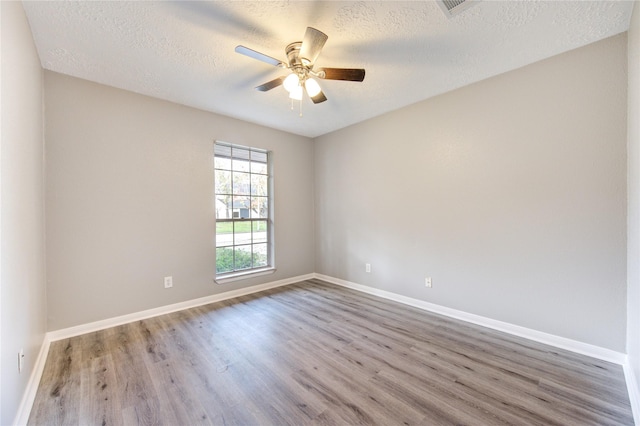 unfurnished room featuring hardwood / wood-style floors, a textured ceiling, and ceiling fan