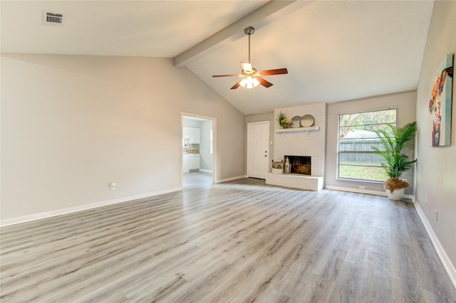 unfurnished living room with high vaulted ceiling, a brick fireplace, light hardwood / wood-style flooring, ceiling fan, and beam ceiling