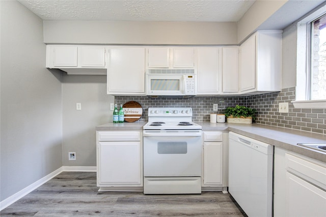 kitchen with white cabinetry, white appliances, and a textured ceiling