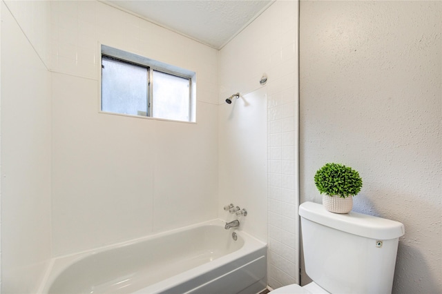 bathroom featuring  shower combination, a textured ceiling, and toilet