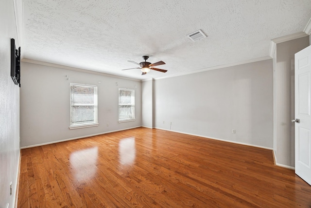 unfurnished room with hardwood / wood-style floors, a textured ceiling, ornamental molding, and ceiling fan