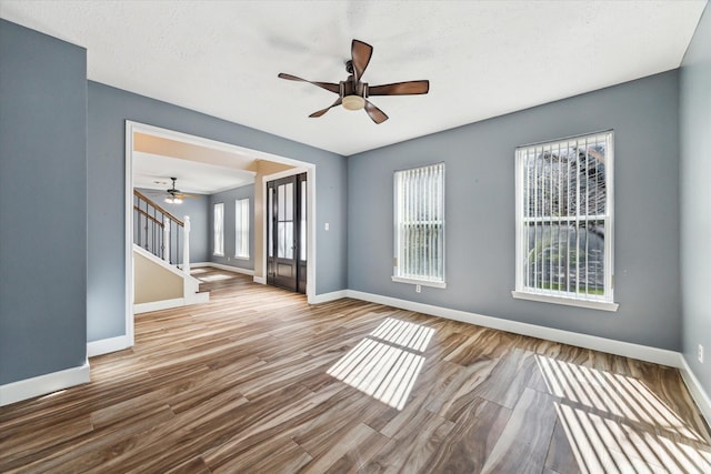 unfurnished room featuring ceiling fan and hardwood / wood-style floors