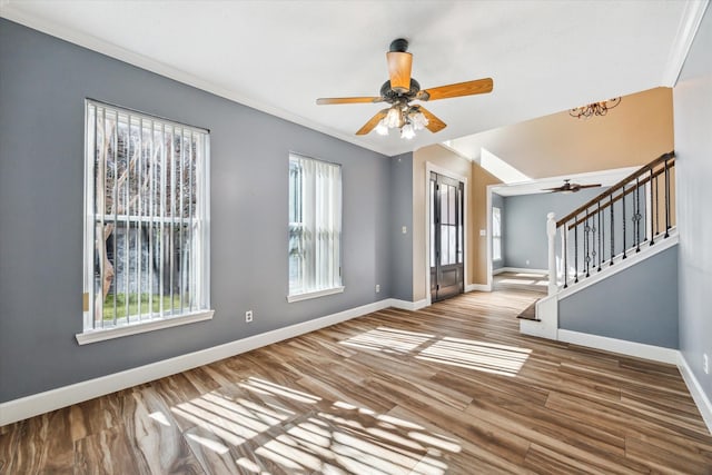 foyer featuring hardwood / wood-style flooring, ceiling fan, and ornamental molding