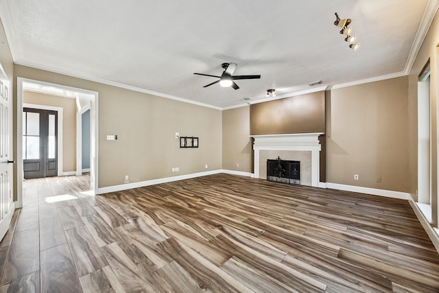 unfurnished living room with french doors, track lighting, ornamental molding, ceiling fan, and hardwood / wood-style floors