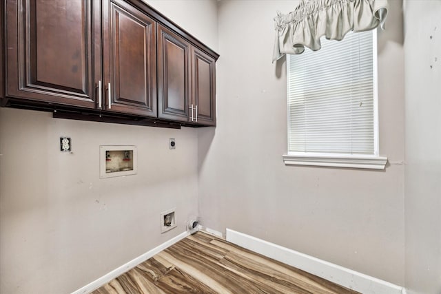 washroom featuring hardwood / wood-style flooring, cabinets, washer hookup, and hookup for an electric dryer